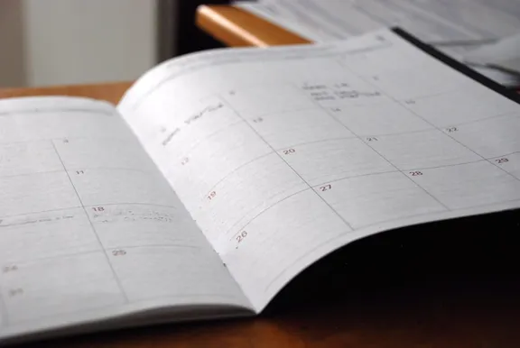 Open job planner on a desk — the week is blank